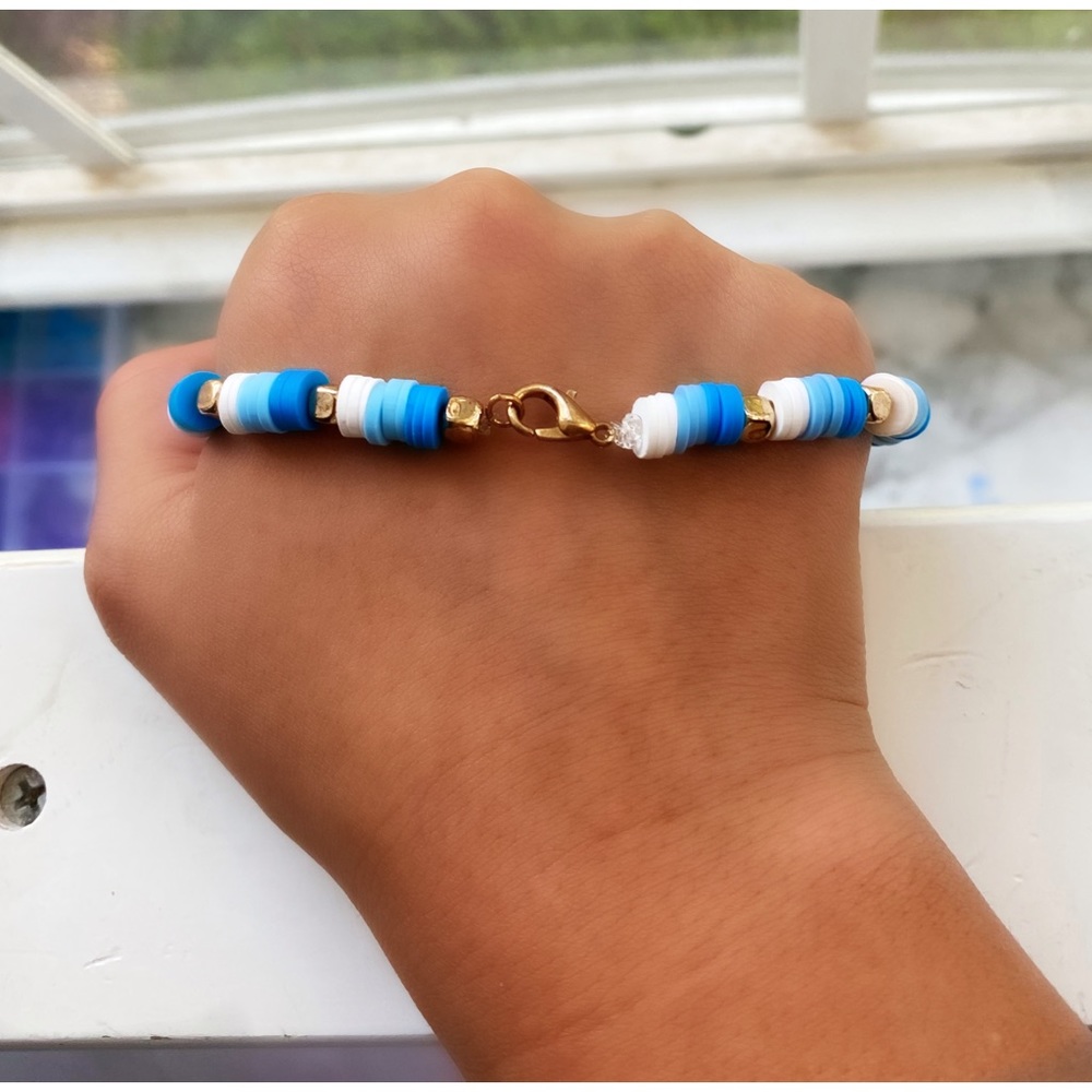 Clay bead winter themed bracelet with blue white and gold